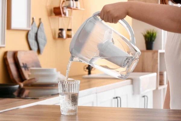 Man Pouring Water Filter Jug Glass Table Kitchen — Stock Photo, Image