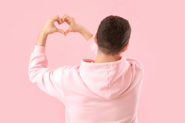 Young Man Making Heart His Hands Pink Background Back View — Stock Photo, Image