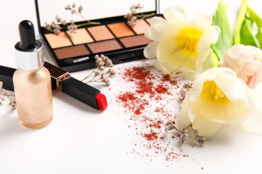 Beyaz arka planda laleleri olan dekoratif kozmetik ürünleri, yakın plan