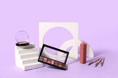 Leylak arkaplan üzerinde ruj, fırça ve podyum sürmüş göz farı