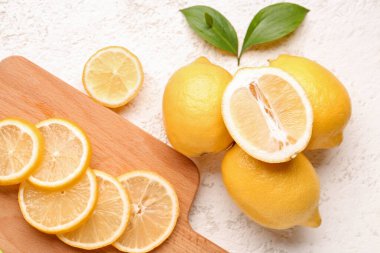 Beyaz arka planda taze limonları olan tahta