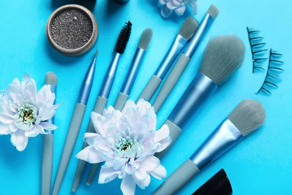Make Pinsel Mit Falschen Wimpern Und Blumen Auf Blauem Hintergrund — Stockfoto