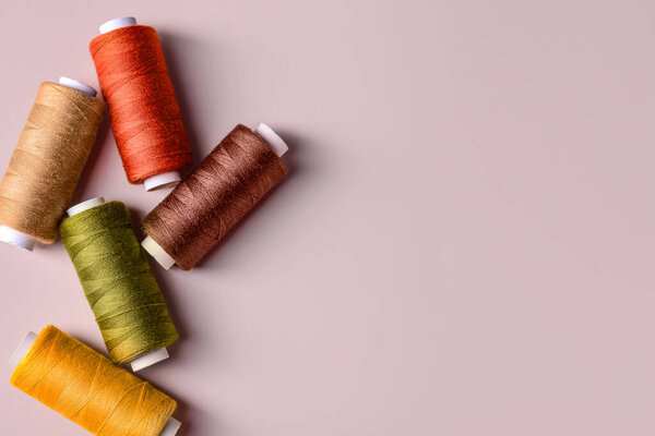 Different sewing threads on color background