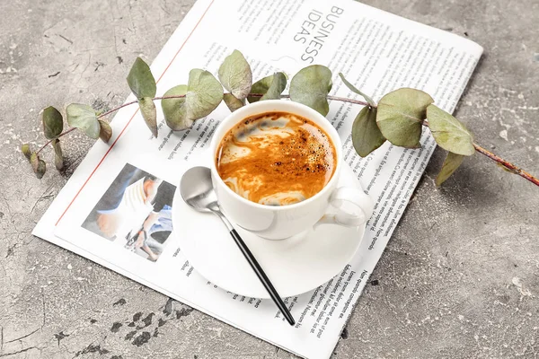 Cup Coffee Spoon Eucalyptus Branch Newspaper Grunge Background — Stock Photo, Image