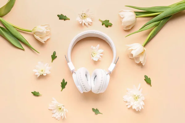 stock image Composition with modern headphones and beautiful flowers on color background