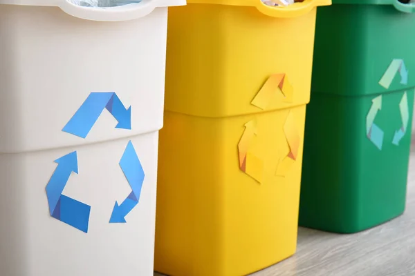 Different garbage bins with recycling symbol