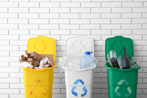 Kosze Śmieci Symbolem Recyklingu Różne Śmieci Pobliżu Ściany Białej Cegły — Zdjęcie stockowe