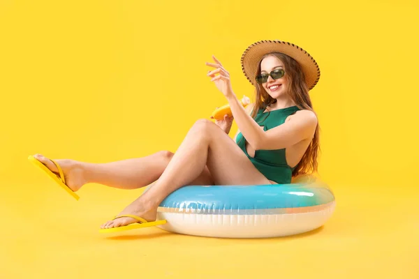 Beautiful Young Woman Sunscreen Cream Inflatable Ring Yellow Background — Stock Photo, Image