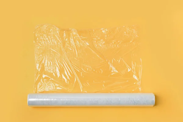 Roll of stretch wrap on yellow background