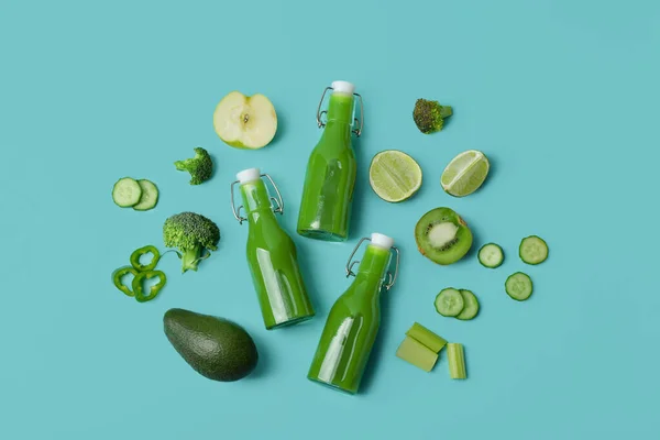 Glass Bottles Tasty Green Juice Ingredients Turquoise Background — Stock Photo, Image