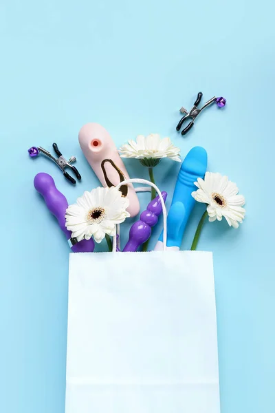 Paper Bag Sex Toys Flowers Blue Background — Stock Photo, Image