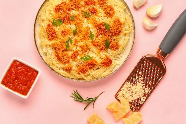 stock image Plate of tasty Italian pasta with Parmesan cheese and sauce on pink background