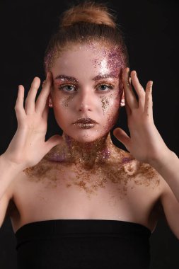 Young woman with glitter makeup on black background, closeup