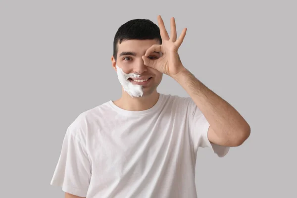 Young Man Shaving Foam Face Showing Light Background — Stock Photo, Image