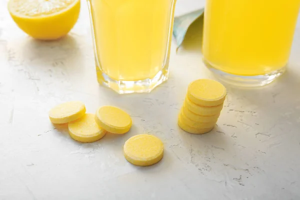 Vitamin C effervescent tablets on white grunge table, closeup