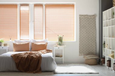 Büyük yataklı, masalı ve pencereli aydınlık yatak odasının içi