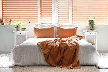 Büyük yataklı, masalı ve pencereli aydınlık yatak odasının içi