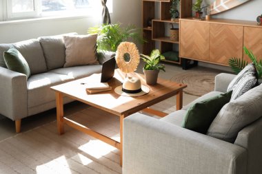 Masası ve kanepesi olan aydınlık oturma odasının içinde.