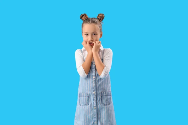 Little Girl Biting Nails Blue Background — Stockfoto