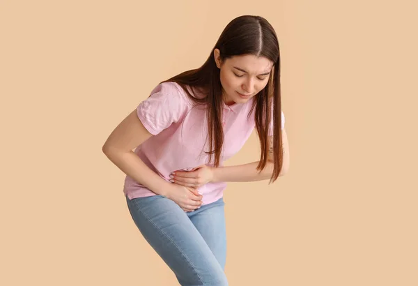 Young Woman Suffering Menstrual Cramps Beige Background — Stock Photo, Image