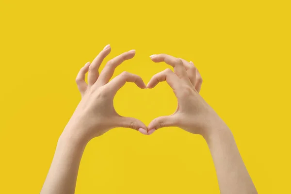 Woman Making Heart Her Hands Yellow Background — Stock Photo, Image