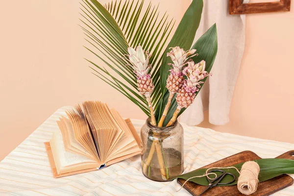 Vase Decorative Pineapples Palm Leaves Book Rope Table Beige Wall — Stock Photo, Image