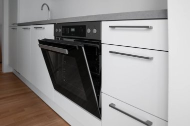Modern electric oven in light kitchen