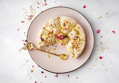 Beyaz arka planda fıstıklı Tahini Halva tabağı