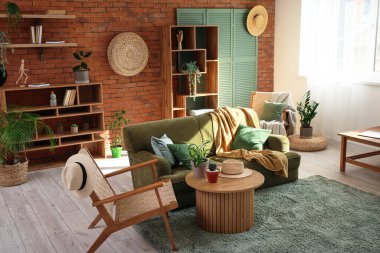 Yeşil kanepesi, koltuğu ve kahve masası olan şık bir oturma odası.