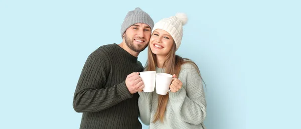 Portrait Happy Couple Winter Clothes Cups Hot Tea Light Background — 스톡 사진