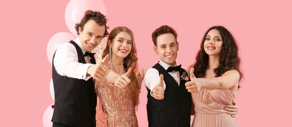 Beautiful Couples Dressed Prom Showing Thumb Gesture Pink Background — Fotografia de Stock