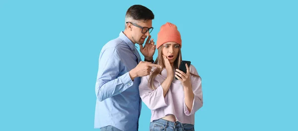 Gossiping people with phone on light blue background