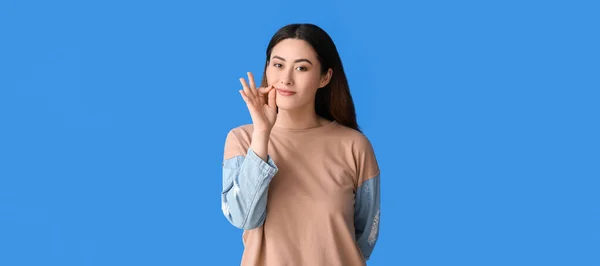 Young Asian Woman Zipping Her Mouth Blue Background — Stock Photo, Image