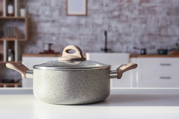 stock image Modern cooking pot on table in kitchen