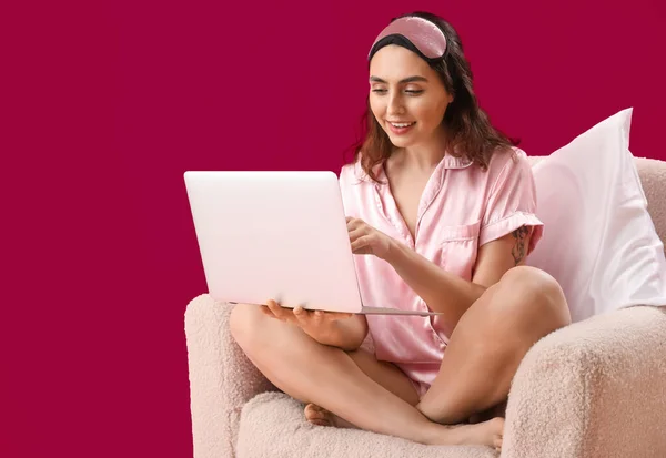 분홍색 배경에 휴대용 컴퓨터를 사용하는 — 스톡 사진