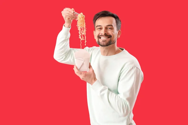 Handsome Man Box Chinese Noodles Red Background — Stockfoto