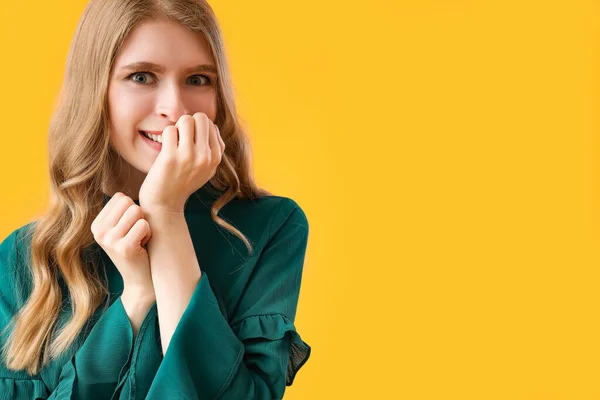Happy Young Woman Biting Nails Yellow Background Closeup — Stock Photo, Image