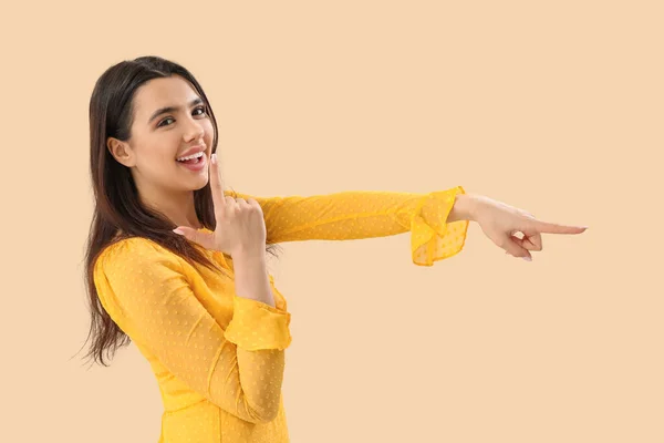 Young Woman Showing Loser Gesture Beige Background — Stock Photo, Image