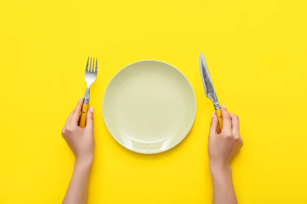 Woman Cutlery Empty Plate Yellow Background — Stock Photo, Image