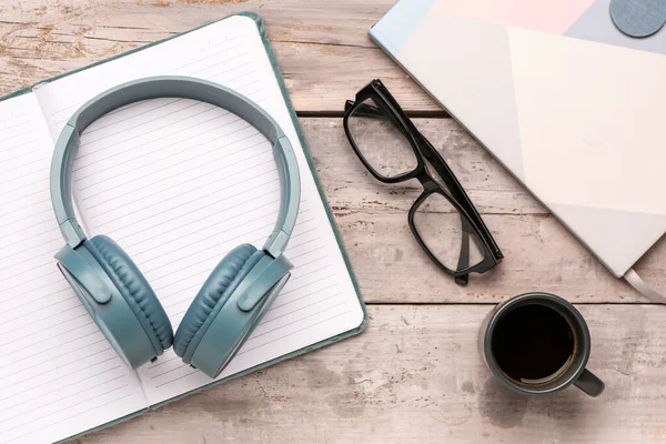 Modern Blue Headphones Notebook Eyeglasses Grey Wooden Background — Stock Photo, Image