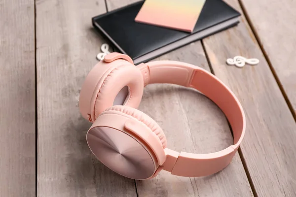 Modern Pink Headphones Notebook Grey Wooden Background — Stock Photo, Image