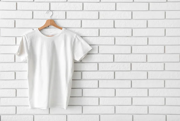 Stylish Shirt Hanging White Brick Wall — Stock Photo, Image