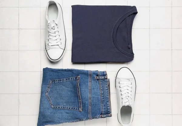Stylish Shirt Jeans Shoes Light Tile Background — Stock Photo, Image
