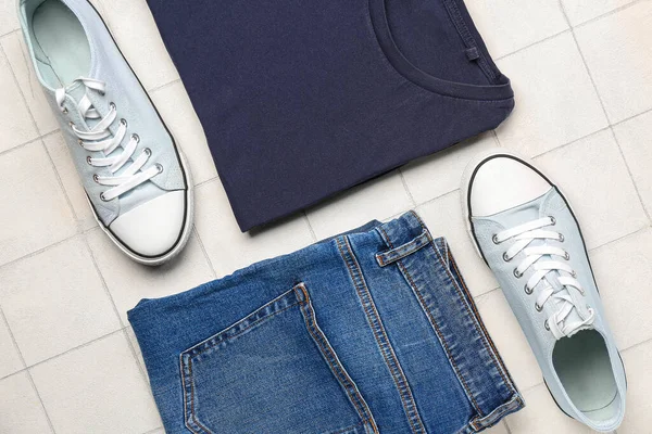 Stylish Shirt Jeans Shoes Light Tile Background — Stock Photo, Image