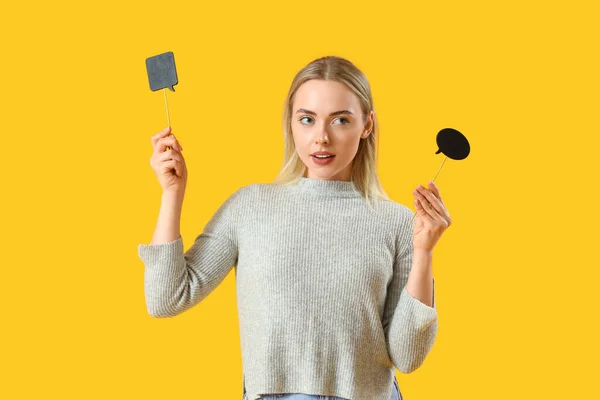 Young woman with speech bubbles on yellow background