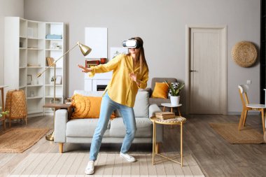 Pretty young woman in VR glasses at home