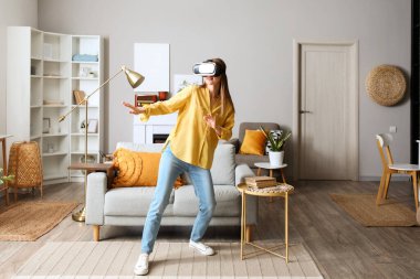 Pretty young woman in VR glasses at home