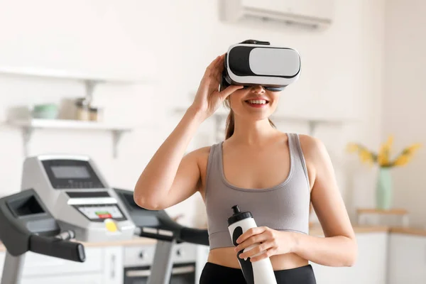 stock image Sporty young woman in VR glasses at kitchen