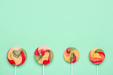 Turkuaz arka planda renkli lolipoplar