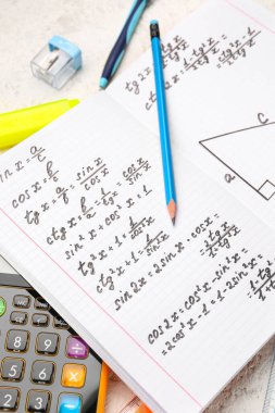 Matematik formülleri ve kalemi olan kitapçık, kapat